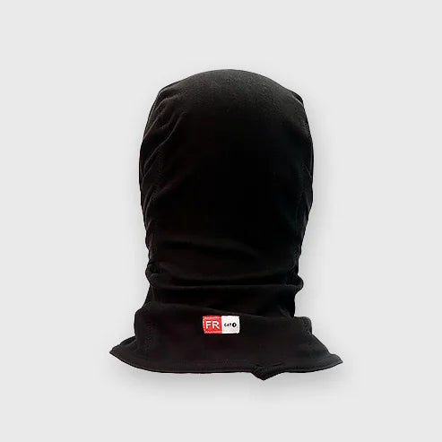 A worker wearing a black Bocomal FR balaclava with a pull-down face mask, providing protection for the head and neck.