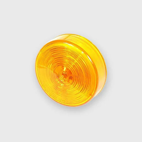 A bright amber 2.5-inch round sealed incandescent light mounted on the side of a truck.