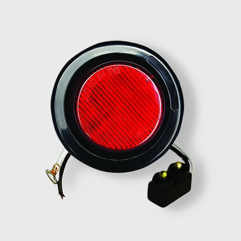 A close-up of a 2-inch red round LED clearance/marker light with 10 LEDs, mounted on a truck.